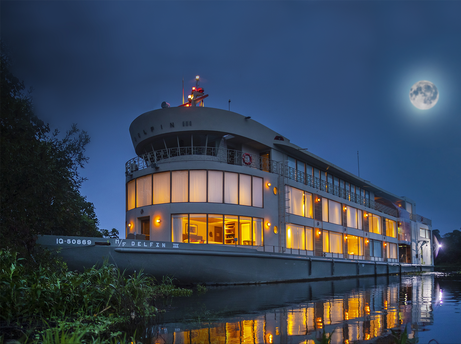 Delfin III river ship illuminated at night on the Peruvian Amazon
