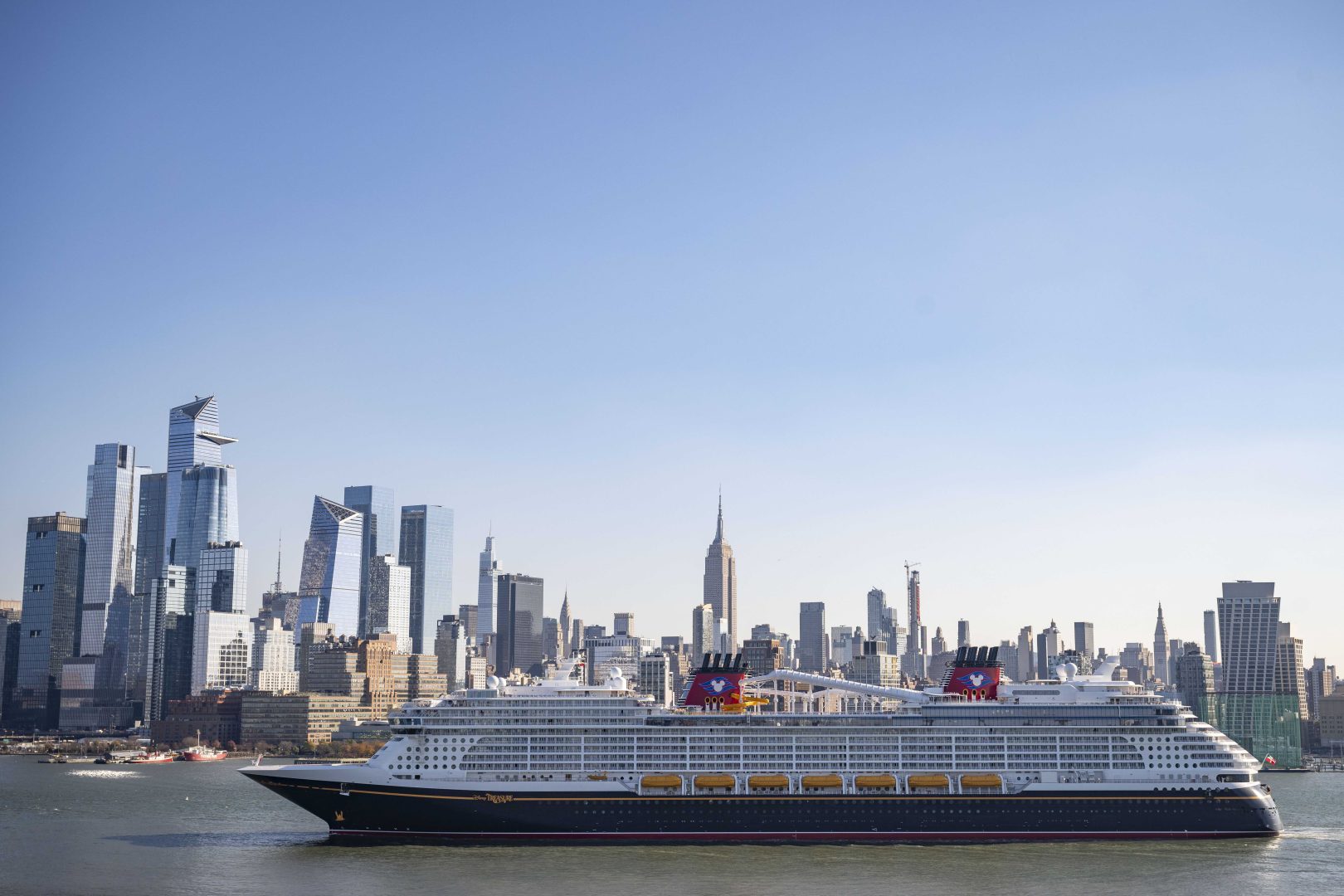 Disney Treasure sailing past the New York City skyline