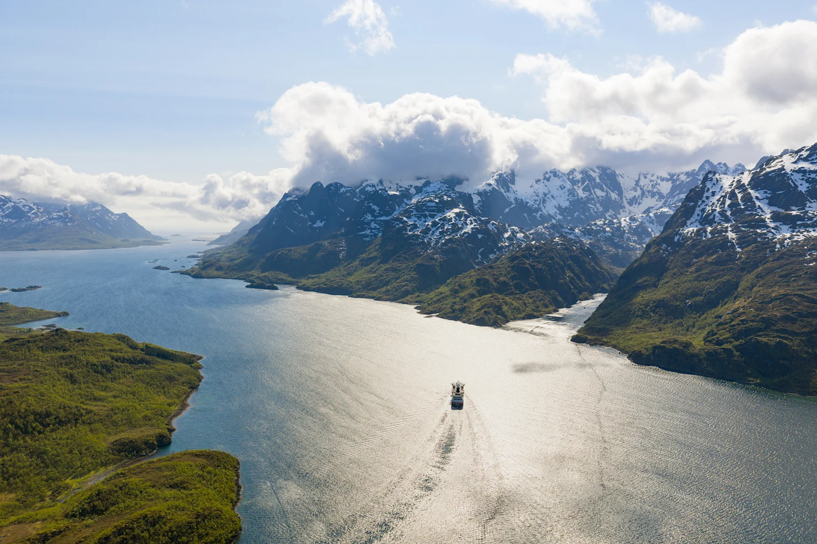 MS Polarlys sailing through Trollfjord between Norwegian mountains